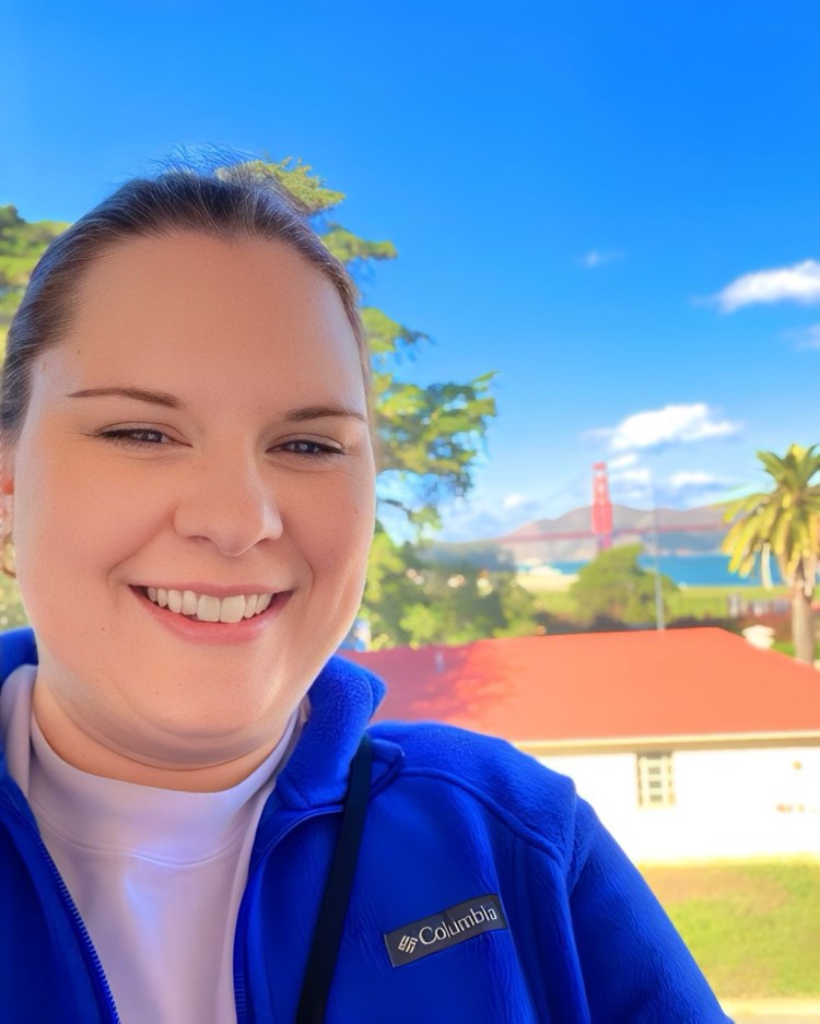 Catherine in San Francisco, with the Golden Gate Bridge in the distance