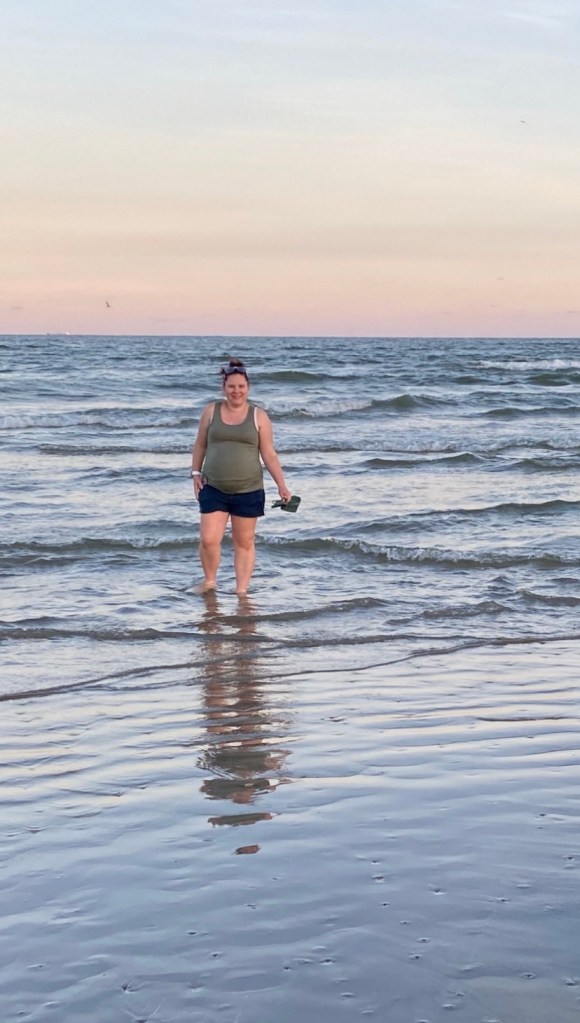 Catherine standing in the Gulf of Mexico around sunset