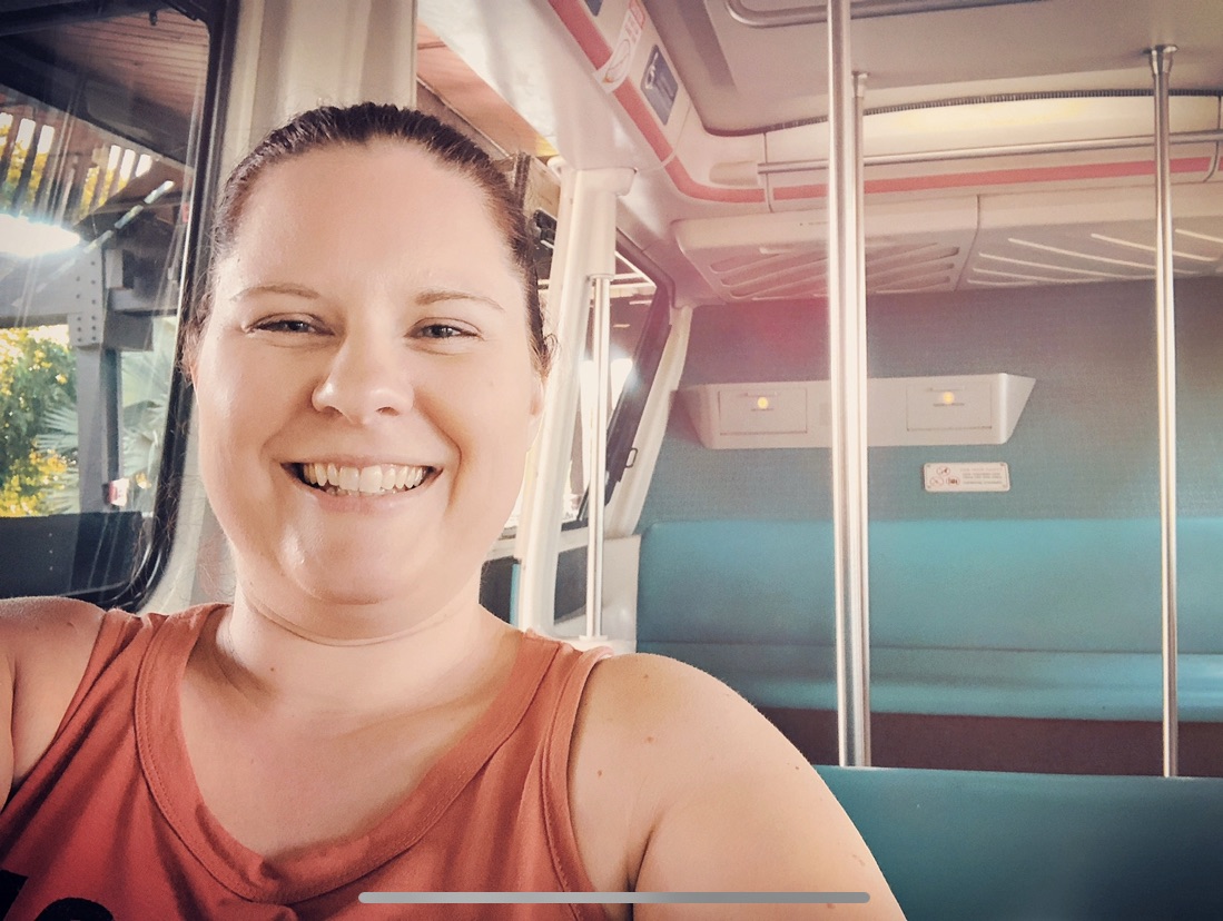 Catherine, sitting in a Monorail Car, in Walt Disney World