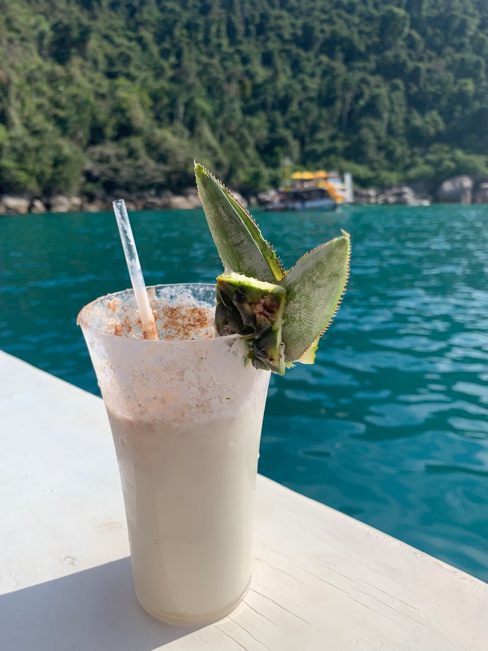 cocktail standing on a ledge by the sea