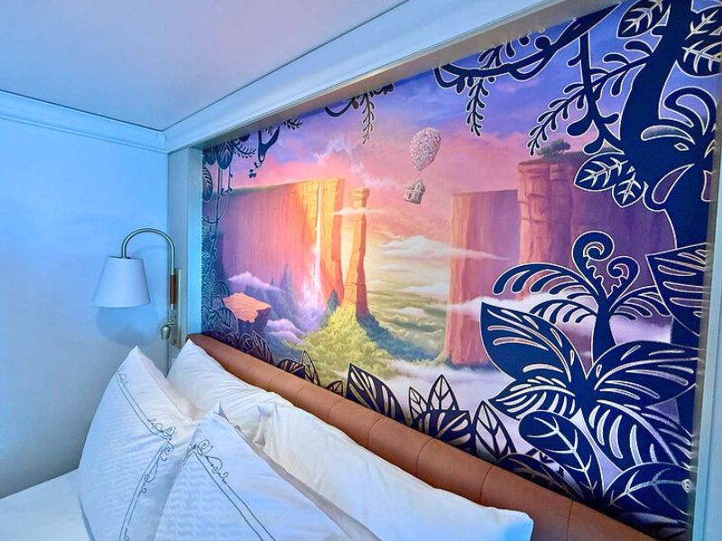 Bed with a scene from the movie "Up" behind it